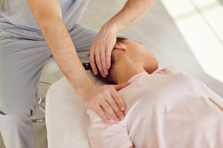 Person stretching their back at home, appearing thoughtful and mildly uncomfortable.